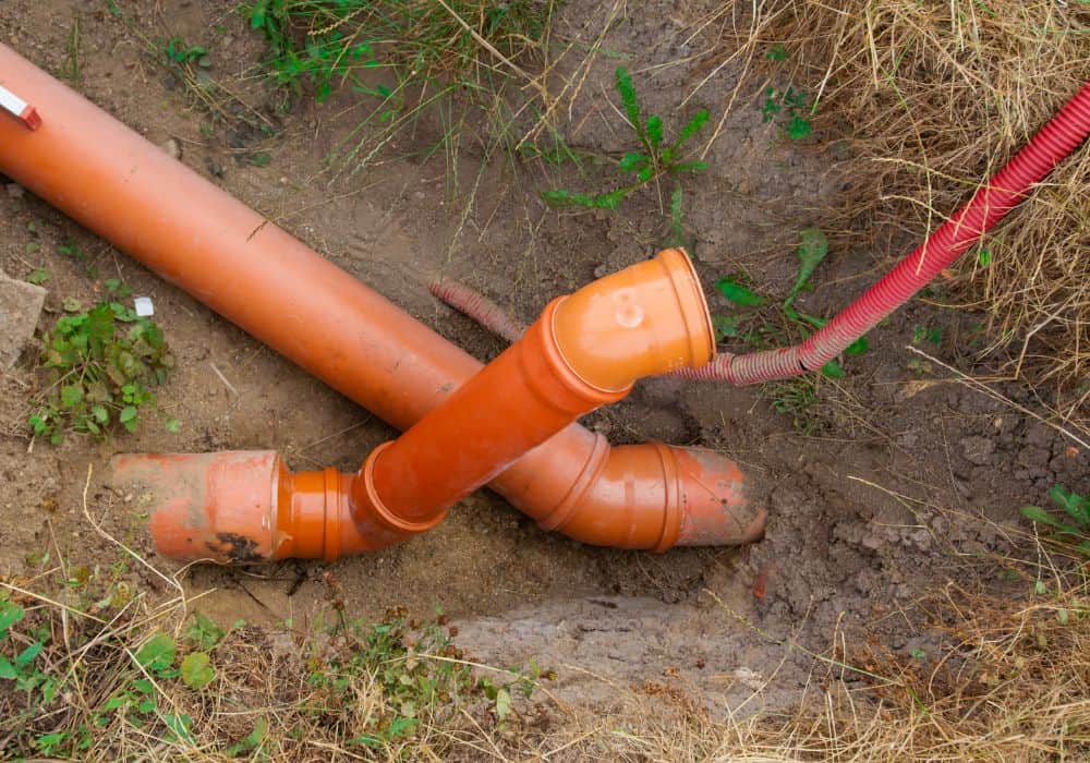 What are the steps in installing a sewer drain pipe?
