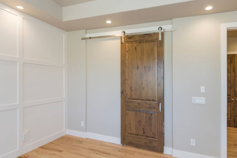 can you hang a barn door from the ceiling?